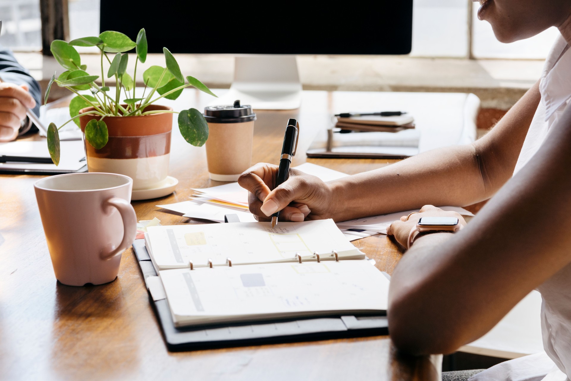 Businesswoman writing on personal organizer schedule